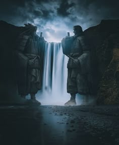 two statues standing in front of a waterfall under a dark sky with clouds above them