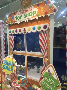 a christmas toy shop display with candy and candies in the window, including toys