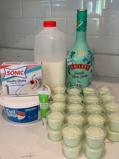 the ingredients to make an ice cream dessert are displayed on a counter top, including milk, yogurt and other items