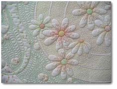 a close up view of a quilt with flowers on it