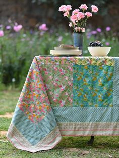 Patchwork Water Flower Table Linen Transform your table setting with the vibrant and eclectic Patchwork Water Flower tablecloth. Featuring a blend of watercolor floral prints and varied patterns, this tablecloth is a boho-chic masterpiece. Each patch is carefully stitched together, showcasing a mix of vibrant colors and textures for a bold, one-of-a-kind look. Handcrafted by skilled artisans, this tablecloth is made from 100% cotton, ensuring both sustainability and durability. Its vibrant hues Quilted Table Cloth, Eclectic Table Settings, Patchwork Tablecloth, Boho Tablecloth, Kitchen Decorations, Flower Table, Watercolor Floral Print, Stitched Together, Colorful Table