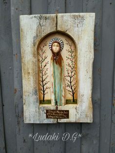 a wooden plaque with a painting of a woman on it