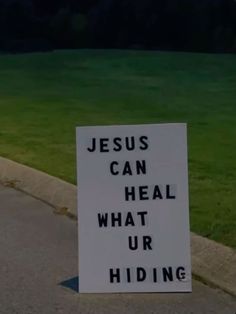 a sign that says jesus can heal what ur hiding is on the side of the road