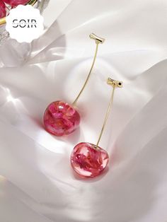 Embrace nature’s beauty with a twist of fun in the FloraCherry Botanical Drop Earrings. These stunning earrings feature long, dangling cherry motifs, each with a glossy red resin "cherry" encasing delicate dried flowers within. The natural blooms are perfectly preserved, adding a touch of earthy elegance to the playful design. Finished with sleek green stems, these earrings are a unique blend of botanical charm and vibrant style, making them the perfect statement accessory for any look. Lightwei Cherry Drop Earrings, Cherry Earrings, Chic Earrings, Alloy Earrings, Long Dangle Earrings, Delicate Earrings, Everyday Earrings, Acrylic Earrings, Floral Earrings