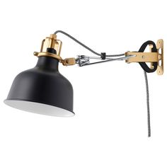 a black and gold wall lamp with a white light on the side, attached to an arm