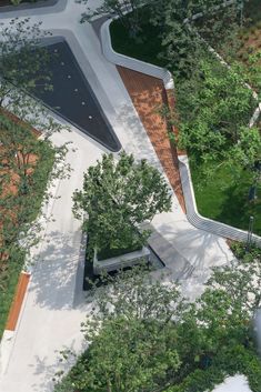 an aerial view of a park with trees and benches