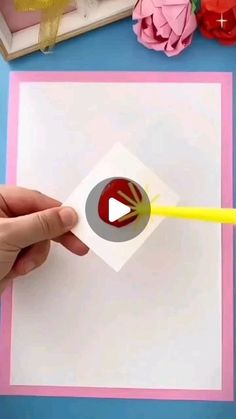 someone is cutting out a card with a yellow sticker on it and then using a sharpie