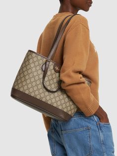 Height: 25cm Width: 31cm Depth: 13cm. Strap drop: 28.5cm. Top handle drop: 12cm. Double fixed straps. Double top handles. Logo details. All over pattern placement may vary. Gold-colored metal hardware. Leather trim. Cotton & linen lining Gucci Top, Gucci Mini, Gucci Ophidia, All Over Pattern, Small Tote Bag, Mini Tote Bag, Small Tote, Mini Tote, Metal Hardware