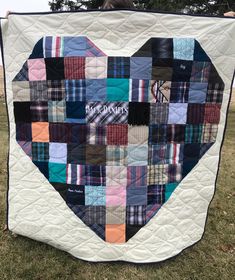 a heart shaped patchwork quilt on the grass