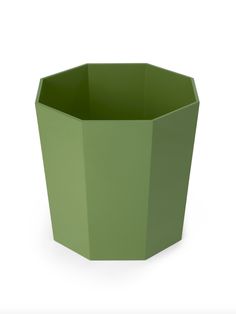 a green planter sitting on top of a white surface