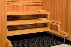 the inside of a sauna with wooden shelves