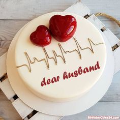 two hearts on top of a cake with the words your good name here