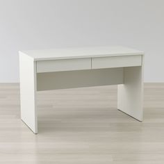 a white desk sitting on top of a hard wood floor