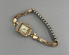 This running 1940s ladies wristwatch by Tavannes of Switzerland features a 14 karat rose gold case, set with six clear, sparkly diamonds. The watch band is gold-filled, and it currently fits a smaller wrist. This band can be replaced, if needed. *Please note: This watch winds up and runs, and it keeps good time. As with all vintage analog watches, I recommend having this watch cleaned and serviced by a watchmaker to ensure accuracy.* The watch case measures about 1 inch long, and the inside of the case back is marked Tavennes 14 K Gold. This watch is in very good original condition, with all diamonds original to the watch. Please see photos for details. US buyers only, please. Free shipping. 1940s Woman, Analog Watches, Pretty Accessories, Vintage Watches Women, Watch Jewelry, Rose Gold Case, Gold Case, Women Wrist Watch, Watches Jewelry