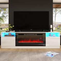 an entertainment center with a television and fire in the fireplace