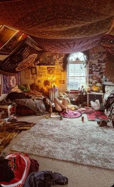 a room filled with lots of different types of clothes and rugs on the floor