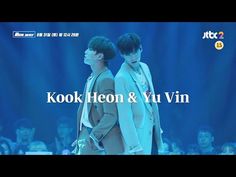 two men standing next to each other in front of blue lights with the words kook heon & yu win