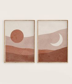 two framed art pieces on a wall in front of a white wall with an orange and pink sunset