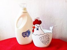 a bottle of milk next to a chicken shaped container on a red tablecloth with a white wall in the background