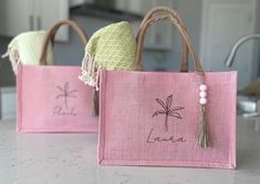 two pink bags sitting on top of a counter