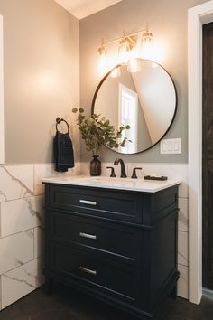 a bathroom with a sink and mirror in it