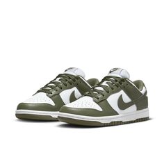 The Nike Women's Dunk Low 'Medium Olive' is the perfect blend of archival hoops style and contemporary design. Showcasing a classic two-tone color scheme, these comfortable sneakers feature a crisp white base with olive green overlays for added depth. The Nike Swoosh further accents the design in color-matched detail. Underpinned by a traditional rubber cupsole, the cushioning foam wedge provides superior comfort and impact protection, while the olive outsole ensures reliable traction when on the court. This updated version of the iconic Be True to Your School series from 1985 delivers timeless appeal with modern performance tech that make sure you stand out in style and comfort. Nike Dunk Low Medium Olive, Dunk Lows, Kitty Pictures, Sneaker Trend, Nike Model, Nike Models, Adidas Spezial, Baskets Nike, Sports Trainers