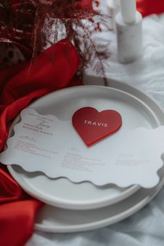 a white plate with a red heart on it