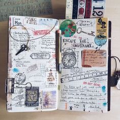 an open notebook with lots of writing and pictures on the pages, along with other items