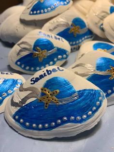 blue and white shoes with gold accents are on a tableclothed cloth, ready to be used as cake toppers