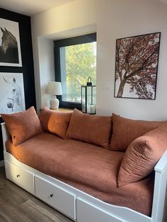 a living room with a couch and some pictures on the wall