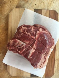 raw meat sitting on top of a cutting board