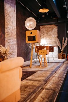 a room with a table, chair and speakers in it