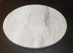 a white marble plate sitting on top of a table