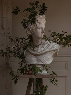 a statue with flowers on top of it