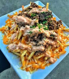 a blue plate topped with fries covered in gravy