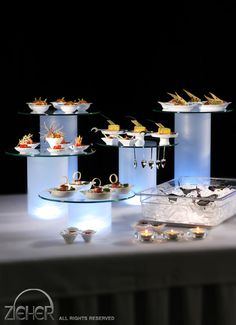 a table topped with lots of food on top of glass shelves next to each other