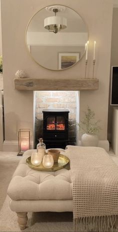 a living room filled with furniture and a fire place next to a mirror on the wall