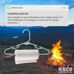 a paper towel hanging over a campfire with the caption'camping hack 1 use a hanger for your toilet paper or paper towels, cut the middle part of the