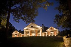 a large house lit up at night with lights on