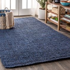 a blue rug in the middle of a living room