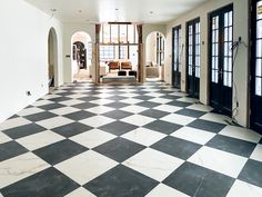 an empty room with black and white checkered flooring