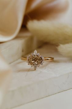 a diamond ring sitting on top of a white box