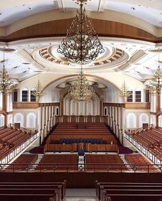 an empty church with chandelier and pews