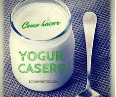 yogurt in a glass jar next to a spoon with the word yogurt casero written on it