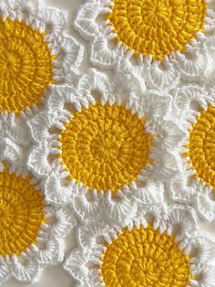 yellow and white crocheted doily with circles