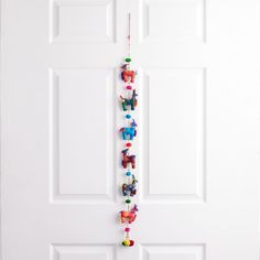 the door is decorated with toy animals and hanging from it's side, as well as on its own string