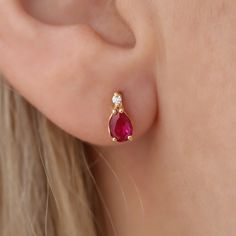 Discover the enchanting allure of our 14K Solid Gold Solitaire Real Diamond Drop Stud Earrings, featuring the radiant ruby, July's birthstone. Crafted with meticulous attention to detail, each earring showcases a premium-grade real diamond at the pinnacle, cascading into a vibrant ruby gemstone, symbolizing love, courage, and passion. Created with the finest 14K solid gold, these earrings promise not only a touch of daily luxury but also durability to last through generations. These earrings mea Ruby Earing Designs, Elegant Red Jewelry For Birthday, Ruby Earrings In Yellow Gold For Gift, Gold Earrings Designs For Daily Use, Elegant Ruby Diamond Earrings, Classic Gold Ruby Earrings, Ruby Yellow Gold Earrings For Gift, Gold Ruby Earrings, Pierced, Daily Luxury