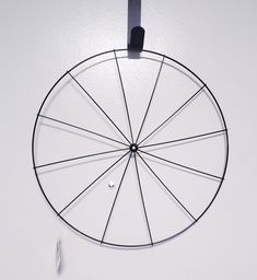 a metal wheel hanging on the wall