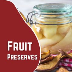 a glass jar filled with fruit preserves sitting on top of a red and white checkered cloth