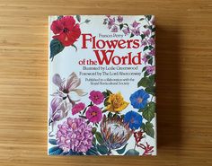 a book on flowers of the world sitting on a table